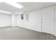 View of finished basement featuring carpeted flooring, access to a large storage area and painted white walls at 9833 White Cascade Dr, Charlotte, NC 28269