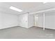 Spacious finished basement with neutral carpet, white walls and multiple closet doors at 9833 White Cascade Dr, Charlotte, NC 28269