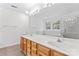 Bright bathroom with a double sink vanity, large mirror, and a view from a window at 9833 White Cascade Dr, Charlotte, NC 28269