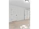 Empty bedroom with neutral carpet, offering doors to closets and hallway, creating a versatile space at 9833 White Cascade Dr, Charlotte, NC 28269