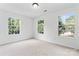 A clean and bright bedroom with three windows providing ample natural light and a neutral carpet at 9833 White Cascade Dr, Charlotte, NC 28269
