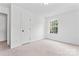 A simple bedroom with a large window offering natural light and a calming atmosphere at 9833 White Cascade Dr, Charlotte, NC 28269
