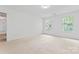 Spacious carpeted bedroom with two large windows overlooking lush greenery at 9833 White Cascade Dr, Charlotte, NC 28269