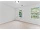 An empty bedroom with neutral carpeting and a large window providing natural light at 9833 White Cascade Dr, Charlotte, NC 28269