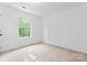 A clean bedroom with a neutral carpet, single window, and ample space for furnishings at 9833 White Cascade Dr, Charlotte, NC 28269
