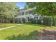 Charming two-story home with lush lawn, mature trees, and manicured shrubbery at 9833 White Cascade Dr, Charlotte, NC 28269