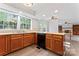 Spacious kitchen with oak cabinets, black appliances, and hardwood flooring overlooking dining and living areas at 9833 White Cascade Dr, Charlotte, NC 28269