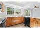 Bright kitchen features a large window, light wood cabinets and black appliances at 9833 White Cascade Dr, Charlotte, NC 28269