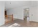 Living room with hardwood floors, white crown molding and banister leading to the carpeted room at 9833 White Cascade Dr, Charlotte, NC 28269