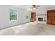 Spacious living room featuring a fireplace, built-in shelving and large windows at 9833 White Cascade Dr, Charlotte, NC 28269