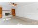 Bright living room features a white brick fireplace and built-in wooden shelving at 9833 White Cascade Dr, Charlotte, NC 28269