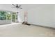 A screened-in porch with a ceiling fan, a door to outside, and views of the trees at 9833 White Cascade Dr, Charlotte, NC 28269