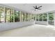 A screened-in porch with a ceiling fan, and views of the surrounding trees at 9833 White Cascade Dr, Charlotte, NC 28269