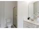 Cozy bathroom with modern toilet, shower and vanity, plus white walls, and tile floor at 10094 Treeside Ln, Matthews, NC 28105