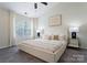Serene bedroom with soft lighting, neutral tones, and a plush bed for ultimate relaxation at 10094 Treeside Ln, Matthews, NC 28105