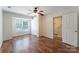 Bedroom featuring wood floors, ceiling fan and natural light from window, plus closet at 10094 Treeside Ln, Matthews, NC 28105