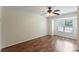Bedroom featuring wood floors, ceiling fan and natural light from window, plus closet at 10094 Treeside Ln, Matthews, NC 28105