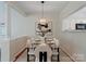 Elegant dining area features modern lighting, a glass table, and stylish seating for sophisticated dining at 10094 Treeside Ln, Matthews, NC 28105