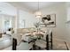 Tastefully staged dining room with a glass table, plush seating, and open flow to the living area at 10094 Treeside Ln, Matthews, NC 28105