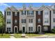 Charming townhome featuring a well-maintained lawn, brick accents, and a welcoming entryway at 10094 Treeside Ln, Matthews, NC 28105
