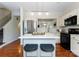 Stylish kitchen featuring a central island with seating, stainless steel appliances, and hardwood floors at 10094 Treeside Ln, Matthews, NC 28105