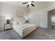 Bright main bedroom featuring plush carpet, ceiling fan and a king bed with tasteful decor at 10094 Treeside Ln, Matthews, NC 28105