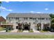 A row of townhomes with decks and garages, offering comfortable and convenient living with outdoor space and parking at 10094 Treeside Ln, Matthews, NC 28105