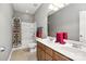 Neutral bathroom with double vanity, shower/tub combination, and patterned shower curtain at 10818 Alvarado Way, Charlotte, NC 28277