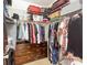 Walk-in closet featuring hanging clothes, shelving, and a wooden dresser at 10818 Alvarado Way, Charlotte, NC 28277