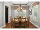Dining room features wood table, chairs, chandelier, and natural light from the windows at 10818 Alvarado Way, Charlotte, NC 28277