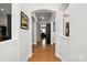 Inviting hallway with hardwood floors and arched doorways creates an elegant transition between rooms at 10818 Alvarado Way, Charlotte, NC 28277