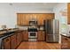 Well-equipped kitchen featuring stainless steel appliances and warm wood cabinetry at 10818 Alvarado Way, Charlotte, NC 28277