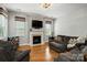 Cozy living room showcasing a fireplace, a mounted TV, and comfortable seating arrangement at 10818 Alvarado Way, Charlotte, NC 28277