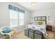 Bright bedroom with patterned quilt, accent pillows, and a decorative bench at the foot of the bed at 10818 Alvarado Way, Charlotte, NC 28277