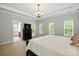 Bright and spacious bedroom with ensuite bathroom and ample natural light from multiple windows at 10818 Alvarado Way, Charlotte, NC 28277