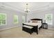 Spacious bedroom with tray ceilings, ample natural light, and a neutral color palette at 10818 Alvarado Way, Charlotte, NC 28277