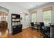 Bright office with natural light, a functional desk setup, and views of the dining room at 10818 Alvarado Way, Charlotte, NC 28277