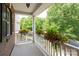 Inviting porch with beautiful floral arrangements and views of lush greenery at 10818 Alvarado Way, Charlotte, NC 28277