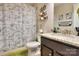 Charming bathroom with dinosaur themed shower curtain, decorative shelves, and granite countertop at 113 Missouri Ln, Mount Holly, NC 28120
