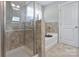Modern bathroom with shower, soaking tub, and neutral tile at 113 Missouri Ln, Mount Holly, NC 28120
