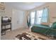 Cozy bedroom with a comfortable bed and a swing chair by a sunlit window at 113 Missouri Ln, Mount Holly, NC 28120