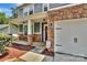 Inviting covered front porch with stone pillars and a hanging porch swing at 113 Missouri Ln, Mount Holly, NC 28120