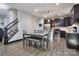 Open concept kitchen with dark cabinets, stainless steel appliances and adjacent dining area at 113 Missouri Ln, Mount Holly, NC 28120