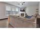 Cozy living room with a fireplace, large windows, and comfortable seating at 113 Missouri Ln, Mount Holly, NC 28120