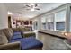 Bright living room featuring hardwood floors, oversized windows, and an open floor plan to the modern kitchen at 113 Missouri Ln, Mount Holly, NC 28120