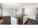 Bright open kitchen with stainless steel dishwasher, gray countertops, and hardwood floors at 1209 Cathey Rd, Charlotte, NC 28214