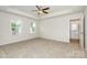 Spacious main bedroom featuring tray ceilings, two windows, carpet flooring, and ensuite bath access at 1235 Cathey Rd, Charlotte, NC 28214