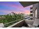 Relaxing balcony with chairs, a lush green view, and an overlooking skyline with sunset at 1300 Reece Rd # 402, Charlotte, NC 28209