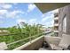 Relaxing balcony with chairs, a lush green view, and an overlooking skyline at 1300 Reece Rd # 402, Charlotte, NC 28209