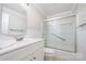 Clean bathroom featuring a shower-tub combo, grab bar, and a bright vanity at 1300 Reece Rd # 402, Charlotte, NC 28209